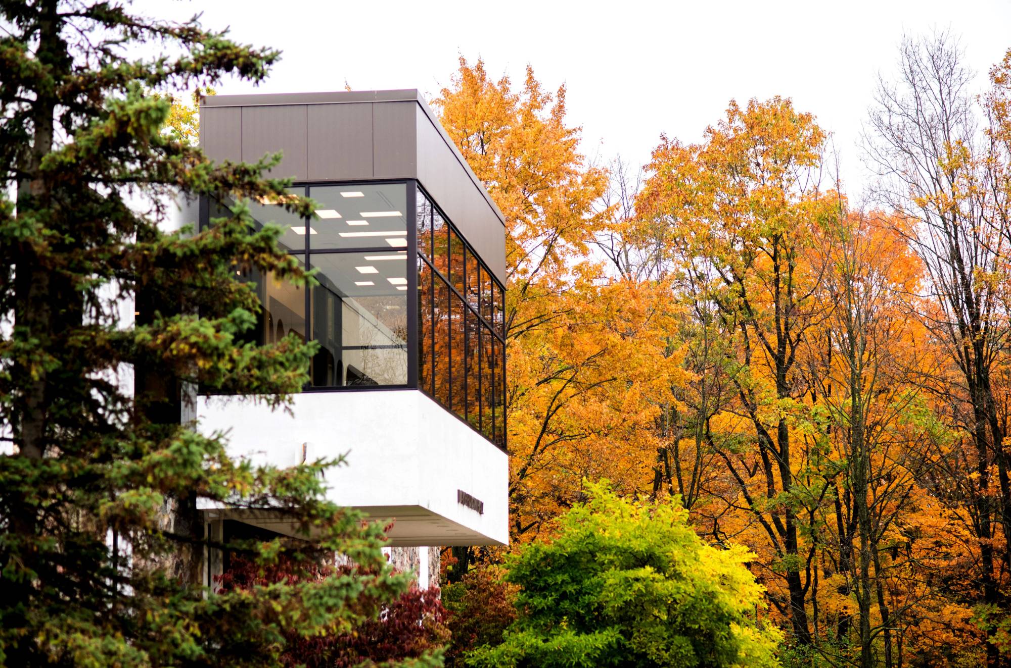 Lake Huron Hall windowed balcony surrounded by fall foilage